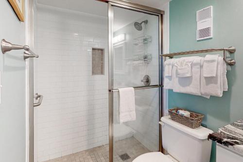 a bathroom with a shower stall and a toilet at #1131 The Mermaid Pad in Gulf Shores