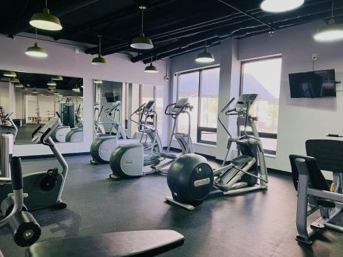 a gym with several treadmills and exercise bikes at Modern Condo DWNTN Hartord XL Center GYM in Hartford