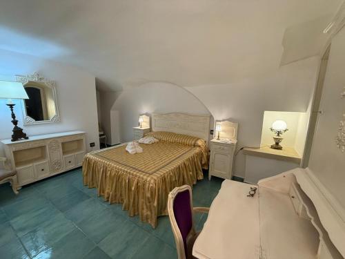 a bedroom with a bed and a table and a mirror at The Crown Palace - Gallipoli in Gallipoli