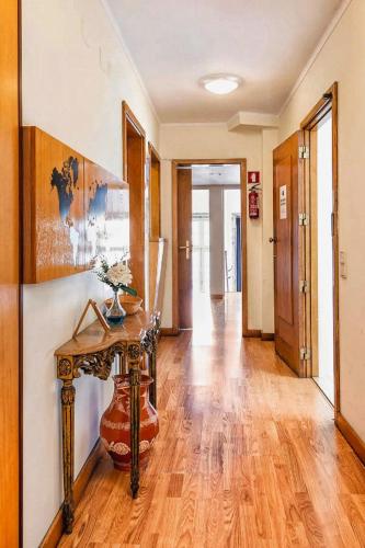a hallway with a console table and a hallway with a hallway at Sir Manuel Guest House - Unidade Centro Histórico in Braga