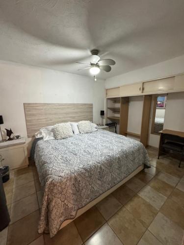 a bedroom with a bed and a ceiling fan at San Carlos Sonora Casa Caracol Condominio in Guaymas