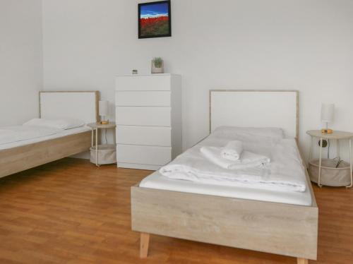 a bedroom with two beds and two tables at großzügiges Apartment I 10 Personen I Einzelbetten I Parkplatz I WLan in Alzey