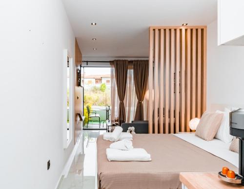 a hotel room with two beds with towels on them at Studio D1 in Kallithea Halkidikis