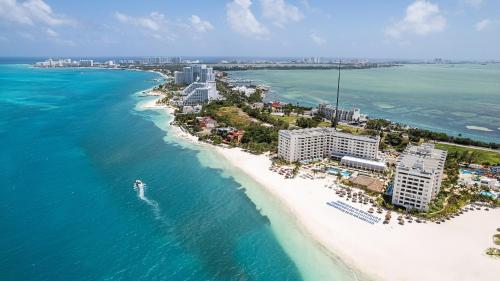 an aerial view of a beach with buildings and the ocean at Melia Casa Maya Cancun All Inclusive in Cancún