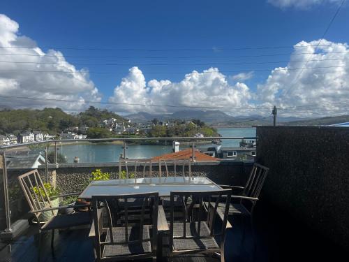 a table and chairs on a balcony with a view at The Quarterdeck in Porthmadog