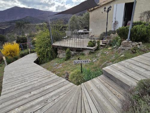 a wooden walkway in front of a house at La Lavande in La Robine