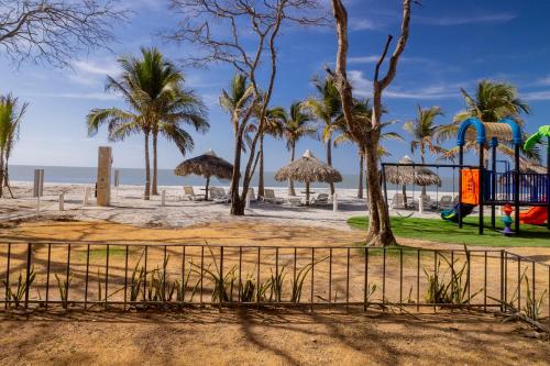 a playground on the beach with palm trees at Sanctuary by Playa Caracol Frente al Mar in Punta Chame