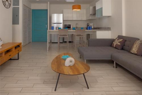 a living room with a couch and a table at Sanctuary by Playa Caracol Frente al Mar in Punta Chame