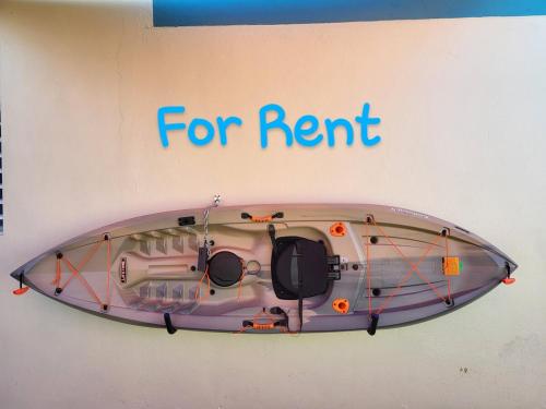 a kayak hanging on a wall with the words for rent at Brisas de Campo in Aguadilla