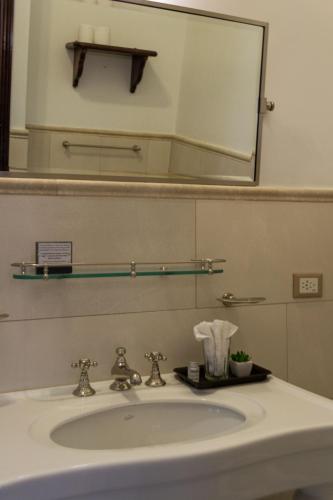 a bathroom with a sink and a mirror at Miravida Soho Hotel & Wine Bar in Buenos Aires