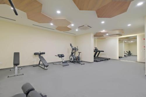 a gym with treadmills and exercise equipment on the walls at Modern Furnished Apartments in Istanbul Basaksehir By Iradah Gayrimenkul in Basaksehir