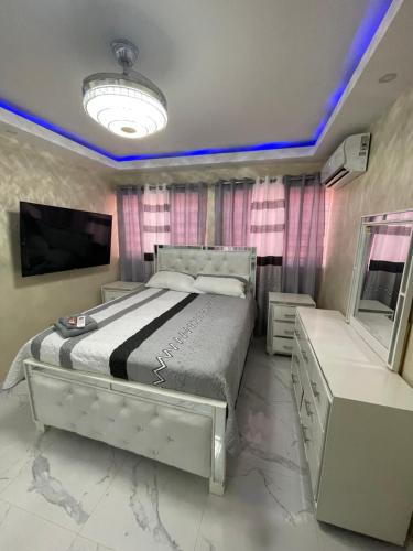 une chambre avec un grand lit et une télévision dans l'établissement Apartamento 2, à Cancino