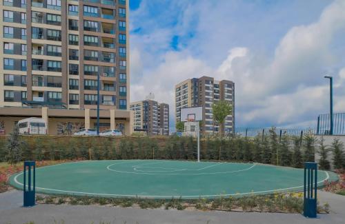 a basketball court in a city with tall buildings at Modern Furnished Apartments in Istanbul Basaksehir By Iradah Gayrimenkul in Basaksehir