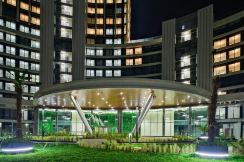 a view of a building at night with tall buildings at Modern Furnished Apartments in Istanbul Basaksehir By Iradah Gayrimenkul in Basaksehir