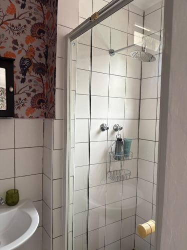 a bathroom with a shower and a sink at Studio at 142 in Durban