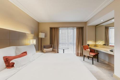 a hotel room with a large bed and a bathroom at InterContinental São Paulo by IHG in Sao Paulo