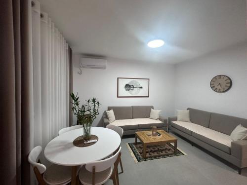 a living room with a couch and a table at Florentina Apartments in Sarandë