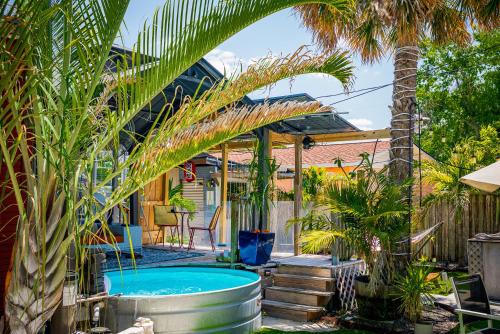 a backyard with a hot tub and palm trees at World Solo Travel's Welcomed At St Pete Home in St. Petersburg