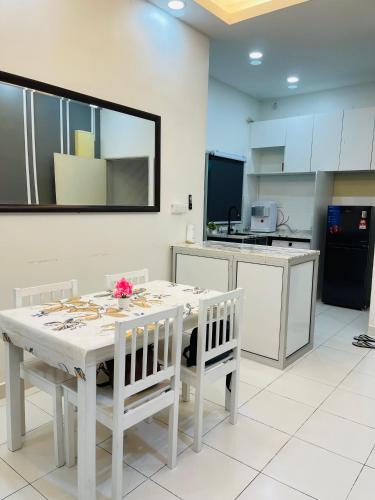 a kitchen with a white table and white chairs at StayD'Cassia in Semenyih