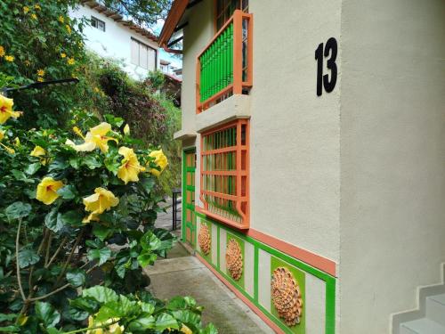 a building with a number on the side of it at Relájate Cerca del Malecón con un Barril Asador para Tus Parrilladas in Guatapé