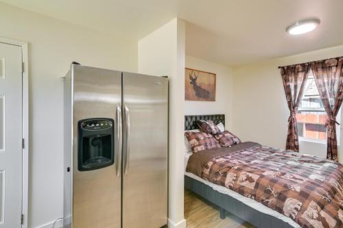 a bedroom with a refrigerator next to a bed at Studio 2 Mi to Feather River Bring Your Pet! in Oroville
