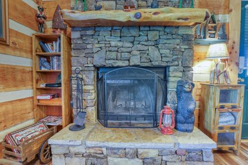 a stone fireplace in a living room with two vases at Bear Pause in Sevierville