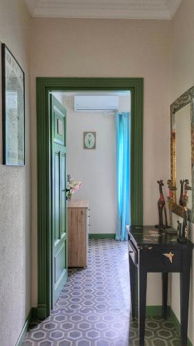 a hallway with a door and a desk in a room at Apartment Mint&Rose in Risan