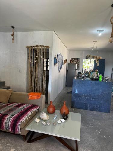 a living room with a couch and a table at Casa de Veraneio in Caucaia