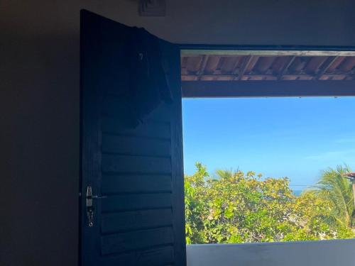 an open door with a view of a window at Casa de Veraneio in Caucaia