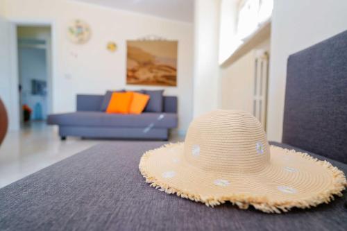 a straw hat sitting on a table in a living room at B&B DANIELA! in Leporano Marina