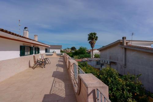 a patio with a fence and tables and chairs at B&B DANIELA! in Leporano Marina
