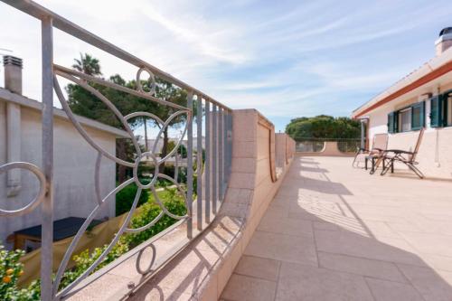 a balcony with a fence and tables and chairs at B&B DANIELA! in Leporano Marina