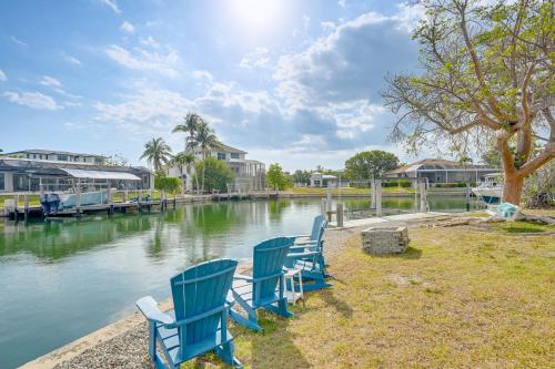 a group of blue chairs sitting next to a body of water at Private Pool, Patio and Peace Marco Island Getaway in Marco Island