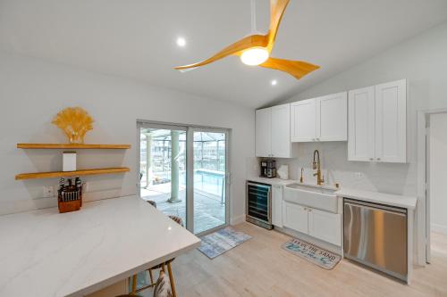 a kitchen with white cabinets and a ceiling fan at Private Pool, Patio and Peace Marco Island Getaway in Marco Island