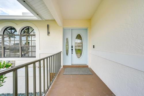 a house with a blue door and a balcony at Private Pool, Patio and Peace Marco Island Getaway in Marco Island