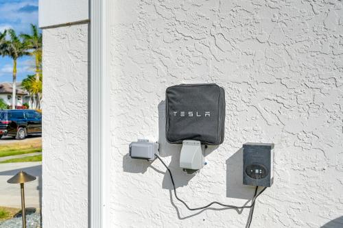 a wall with a cell phone and a box on it at Private Pool, Patio and Peace Marco Island Getaway in Marco Island