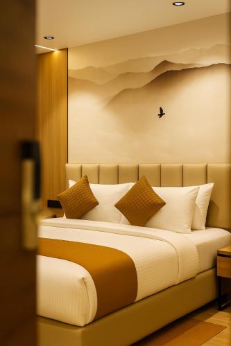 a bedroom with a large bed with a bird on the wall at Monte Verde in Dehradun