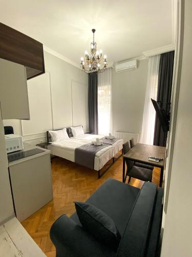 a living room with a bed and a table at Aparthotel Mtatsminda in Tbilisi City