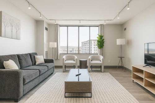 a living room with a couch and a tv at Downtown Hartford Condo - Bushnell Park - Convention Center in Hartford