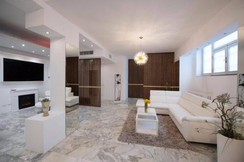 a living room with a white couch and a fireplace at La Galleria in Milan