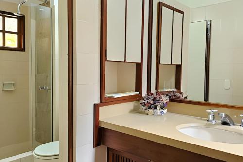 a bathroom with a sink and a toilet and a mirror at Reserva tu casa rodeada de naturaleza en Villeta in Villeta