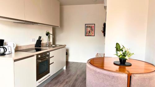a kitchen with a wooden table and a dining room at The Bristol Vault in Bristol
