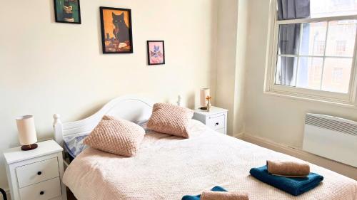 a bedroom with a bed with two towels on it at The Bristol Vault in Bristol