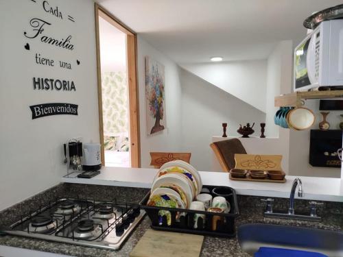 a kitchen counter with a sink and a stove at A 4 Minutos del Malecón con Barril Asador, Ideal para Relajarte y Compartir in Guatapé