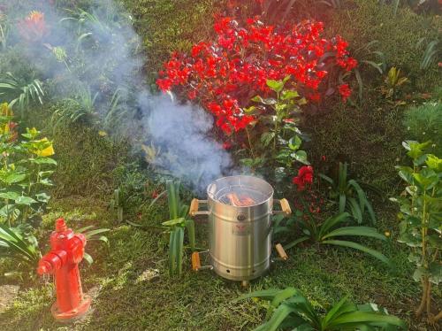 a fire hydrant with smoke next to a red fire hydrant at A 4 Minutos del Malecón con Barril Asador, Ideal para Relajarte y Compartir in Guatapé