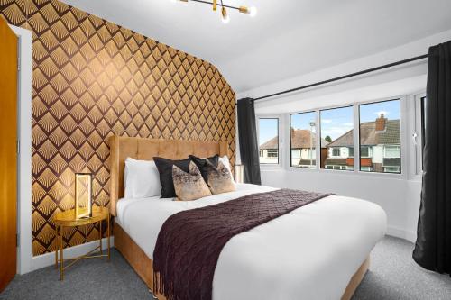 a bedroom with a large bed and a large window at Stylish Four Bedroom House - Garden - Parking - Great Barr 110F in Birmingham