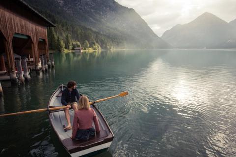 a man and a woman in a boat on a lake at Appartement Gipfelblick- Tiroler Zugspitze Arena in Biberwier in Biberwier