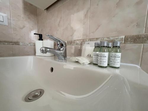 two bottles of essential oils sitting on a bathroom sink at Villa Incanto Pina - Torre Canne in Torre Canne