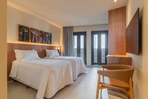 Кровать или кровати в номере Gorges Residence Salvador