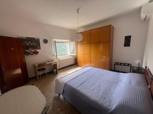 a bedroom with a bed and a table and a window at B&B Locanda Pinà - Room 1 in Montemarciano